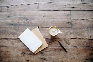 A virtual assistants notepads and coffee